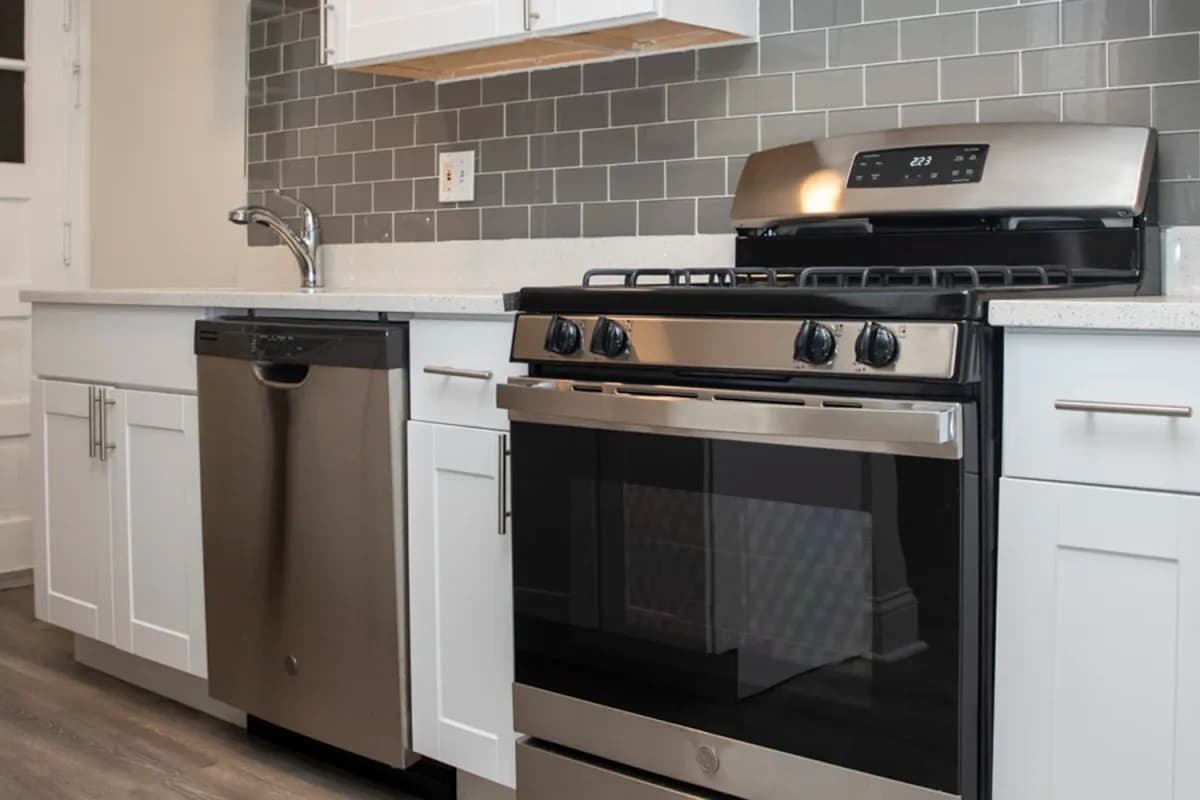 1251 W. Henderson St, Apt 1 — kitchen view toward stainless range and cabinetry