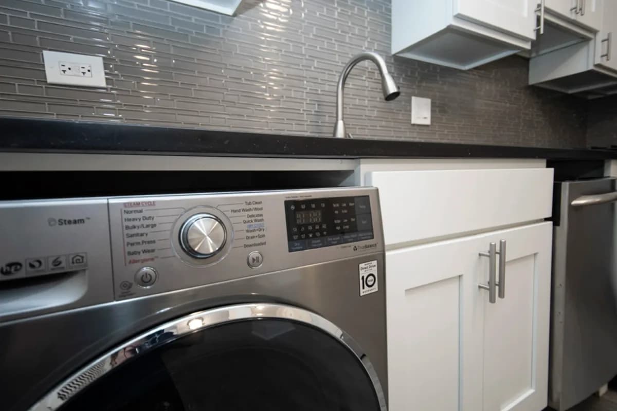 646-48 W. Roscoe St, Apt 648-5-gd — LG stacked washer-dryer with steam cycle built into the kitchen counter