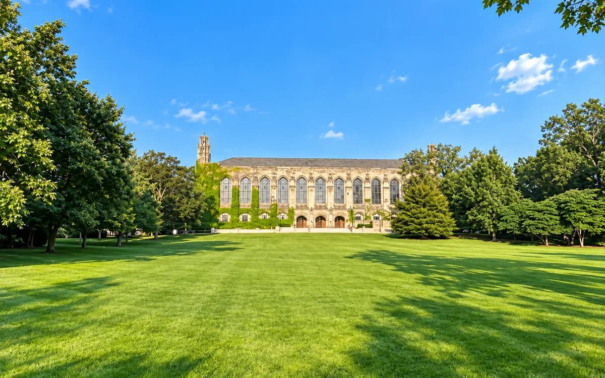 The collegiate-gothic limestone facade of Deering Library at Northwestern University, seen across its front lawn