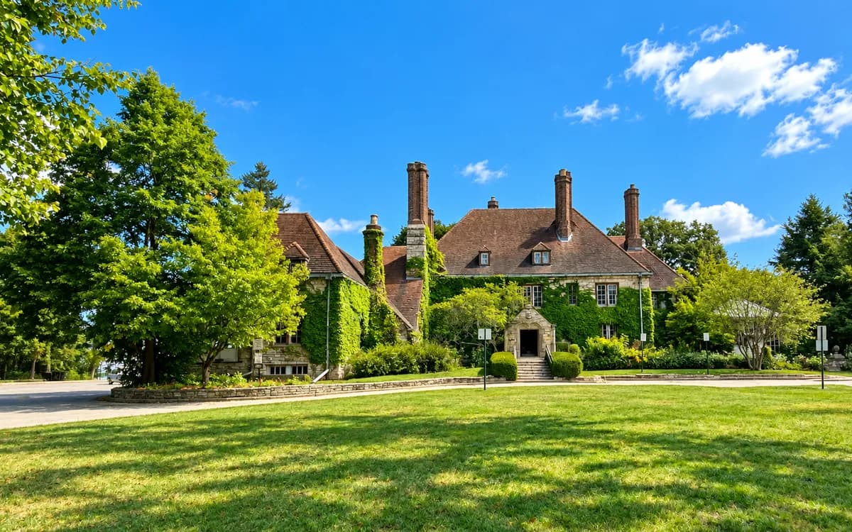 The ivy-covered historic Harley Clarke Mansion set in the green lakefront grounds of Lighthouse Landing Park, Evanston